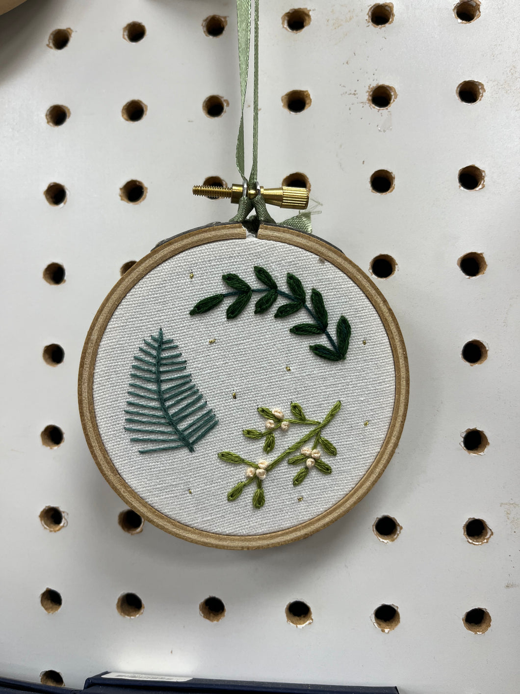 Hand embroidered foliage on mini hoop.