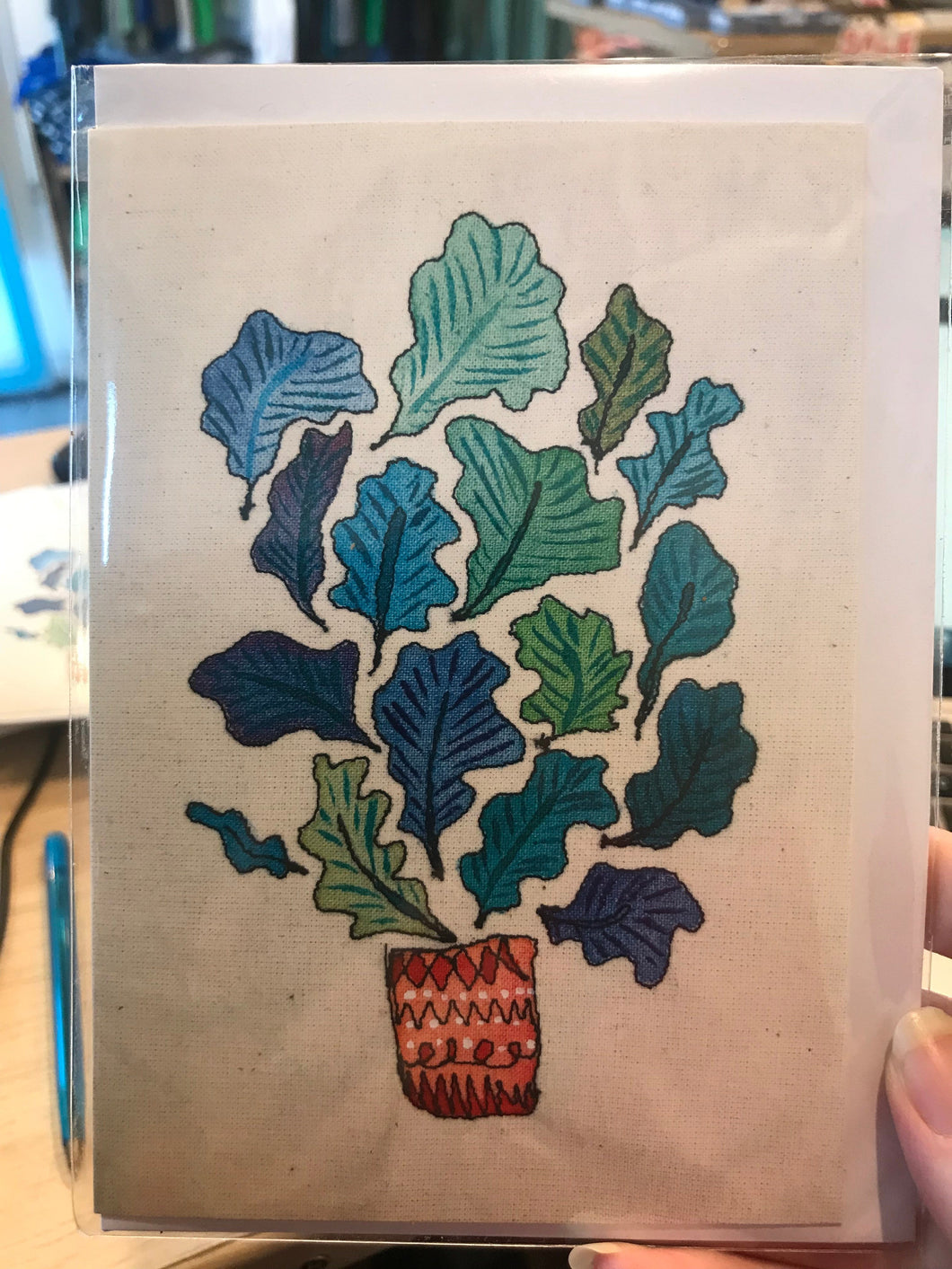 Blue and green leaves with red pot card